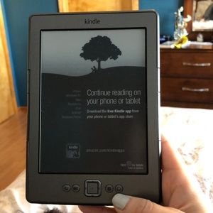 Kindle with charging cord and reading light.